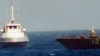 At Sea -- An IRGCN boat heads towards the USS Thunderbolt in the Gulf, July 25, 2017