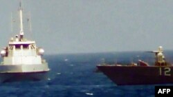 An IRGC navy boat heads towards the USS Thunderbolt in the Gulf, July 25, 2017