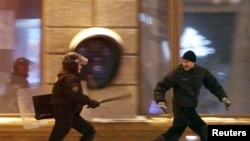 A riot policeman chases an opposition protester during demonstrations in Minsk in December. 
