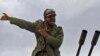 A rebel fighter reacts to incoming shells fired by soldiers loyal to Moammar Qaddafi. The rebels started out strong, but appear to be losing territory day-by-day.