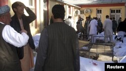 Relatives of victims cry at a local hospital after the bomb blast in Faryab Province.