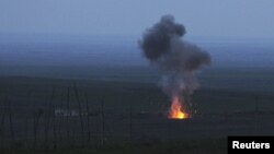 Nagorno-Karabakh -- Smoke from fire rises above the ground in Martakert district, after an Israeli-made Azerbaijani "suicide" drone was shot down by the Karabakh army, 4 April 2016.