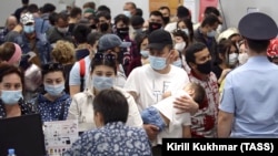 Uzbek migrant workers wait to check in for a flight to Tashkent at Tolmachevo Airport near Novosibirsk in 2020. Oson and Pay Way handle a large amount of remittances from Uzbeks living in Russia.