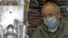 France -- A man working in a news-stand wears a protective face mask in central Paris, France, 04May2009