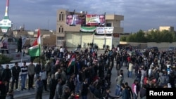 Antigovernment demonstrators protest in Amude, Syria, on December 27.