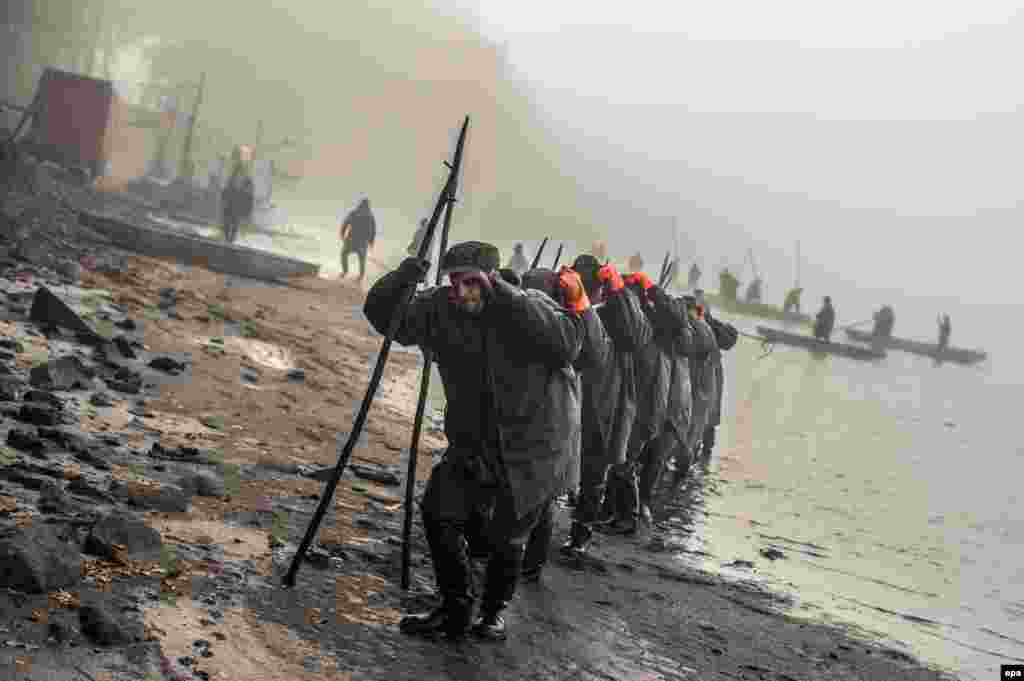 Czech fishermen pull a net in during the traditional carp haul at Lake Zablatsky near Trebon on October 31. (epa/Filip Singer)