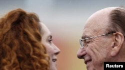 News Corporation International chief executive Rupert Murdoch (right) with executive Rebekah Brooks, a former "News of the World" editor who is currently under intense media scrutiny (file photo)