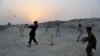 Boys play cricket at sunset on the outskirts of Jalalabad, Afghanistan. (AFP/Noorullah Shirzada)