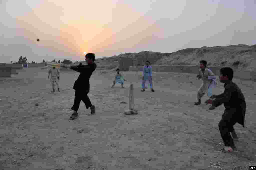 Boys play cricket at sunset on the outskirts of Jalalabad, Afghanistan. (AFP/Noorullah Shirzada)