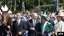 A horse-racing enthusiast, the Aga Khan (second from left) is spiritual leader to millions of Ismaili Muslims.