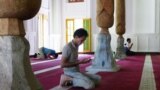 Muslim men pray in a mosque near Tashkent. 