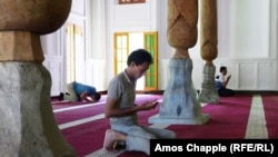 Muslim men pray in a mosque near Tashkent. 