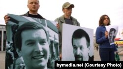 Protesters hold pictures of Belarusian opposition politician Viktar Hanchar (left) and businessman Anatol Krasouski. Both men have been missing since 1999. (file photo)