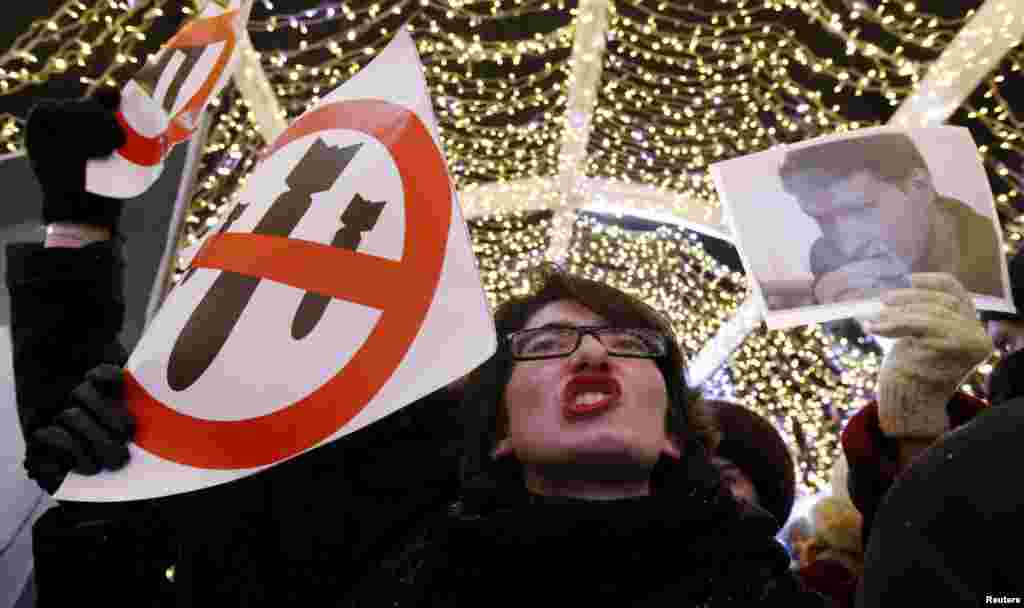 A participant shouts slogans and holds a portrait of human rights lawyer Stanislav Markelov, who was killed together with journalist Anastasia Baburova by a nationalist extremist on January 19, 2009, during an antifascist rally to commemorate them in central Moscow on January 19. (Reuters/Sergei Karpukhin)