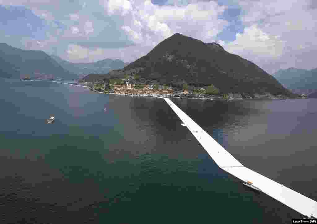 An aerial view of the installation of The Floating Piers by Christo on Lake Iseo in northern Italy in June 2016. Some 200,000 floating cubes created a 3-kilometer runway that was clad in bright yellow fabric and connected the town of Sulzano to the small island of Monte Isola.