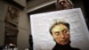 A man holds a portrait of slain Russian journalist Anna Politkovskaya during a rally marking the eighth anniversary of her death in Moscow on October 7, 2014.
