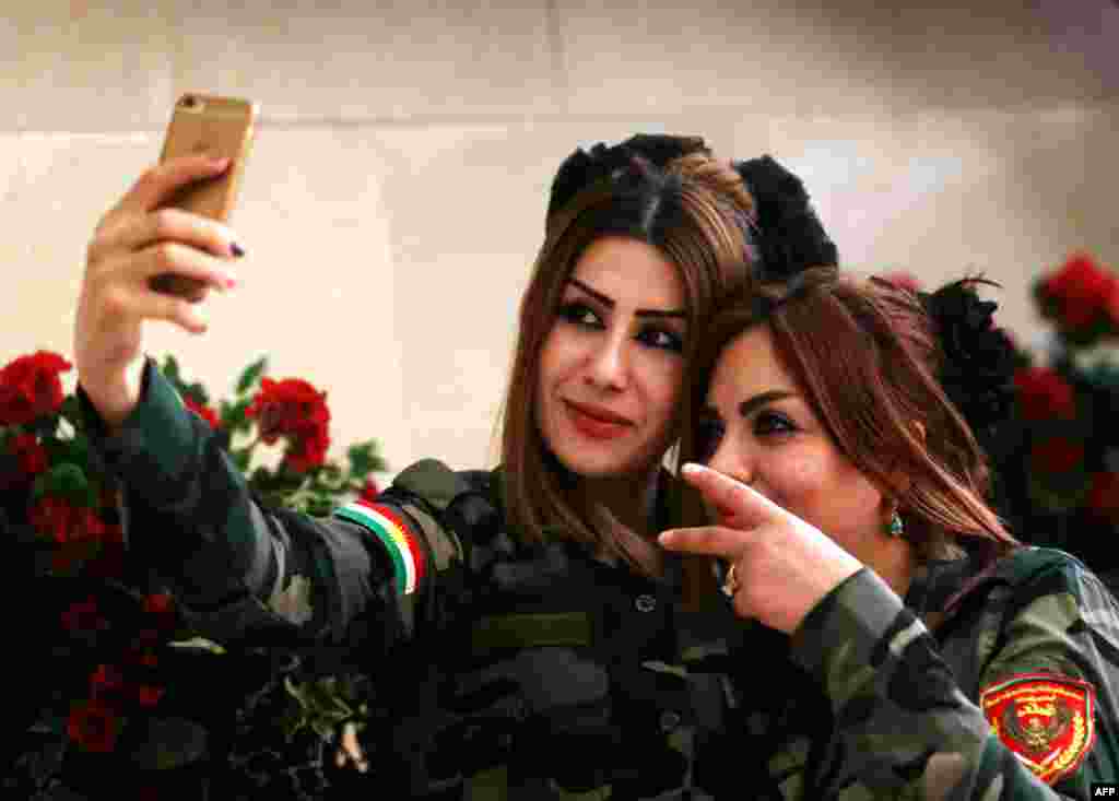 Female Peshmerga fighters take a selfie in Irbil, the capital of the Kurdish autonomous region. (AFP/Safin Hamed)