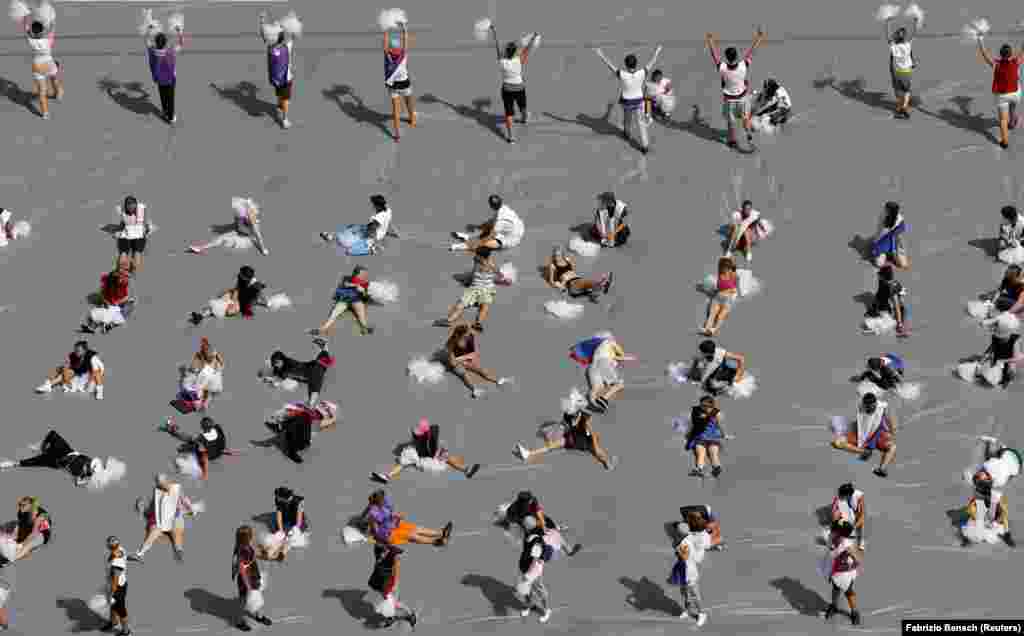 Volunteers take a break during rehearsals for the opening ceremony of the 14th International Association of Athletics Federations World Championships at the Olympic stadium in Moscow. (Reuters/Fabrizio Bensch)