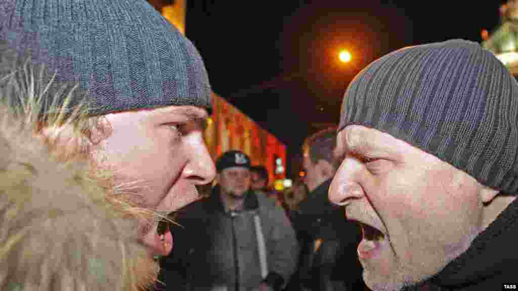 Pro-Kremlin and opposition demonstrators shout at each other during rallies held in Moscow on December 6 in the wake of parliamentary elections that were controversially won by the ruling United Russia party. (Photo for ITAR-TASS by Maksim Novikov)