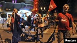 "No" supporters carry a burned EU flag in Thessaloniki after victory in the referendum.