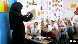 Iran -- A teacher and schoolgirls in a classroom, undated. File photo