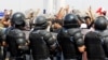 Security forces stand guard as demonstrators protest over unemployment, corruption and poor public services, in Baghdad, October 2, 2019.