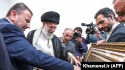 Iranian Supreme Leader Ayatollah Ali Khamenei (2nd-L) points at a framed relief depicting Jerusalem and the Dome of the Rock during his meeting with Hamas' deputy chief Saleh Arouri (L) and other members of the delegation in the capital Tehran, July 22, 2019