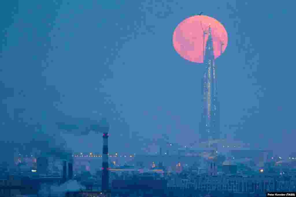 A super blue blood moon is seen above the tower of the Lakhta Center, which is under construction in St. Petersburg, Russia. (TASS/Peter Kovalev)