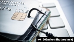 Generic - Credit card phishing - piles of credit cards with a fish hook on computer keyboard, ©Shutterstock photo, undated