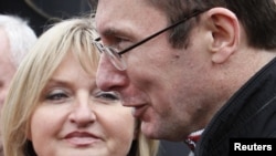 Lutsenko talks to the media as his wife, Irina, looks on after leaving a prison in the settlement of Makoshino.