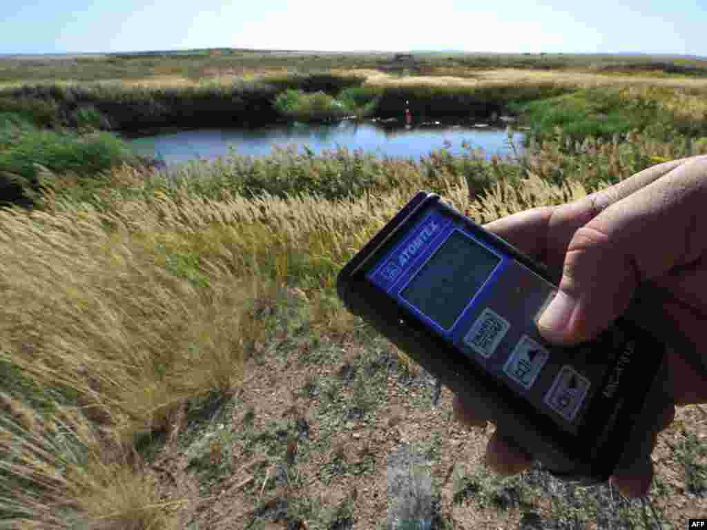 The soil near a crater formed by a nuclear explosion still has dangerous exposure readings.