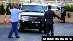 United Nation vehicles carrying Organization for the Prohibition of Chemical Weapons inspectors arrive in Damascus on April 14.