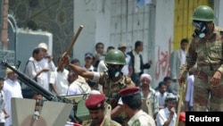 Soldiers block an antigovernment demonstration in the southern city of Taiz on April 7.