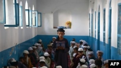 Afghan boys study the Koran at a madrasah during the month of Ramadan in Kandahar.