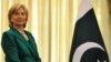 U.S. Secretary of State Hillary Clinton stands next to a Pakistani national flag before a meeting with Prime Minister Yousaf Raza Gilani in Islamabad on October 28.