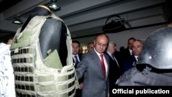 Armenia - Defense Minister Seyran Ohanian inspects a flak jacket manufactured by a Polish-Armenian joint venture in Charentsavan, 16Oct2014.