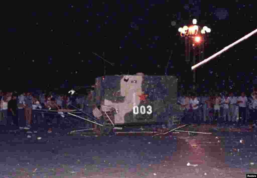 An armoured personnel carrier crushes one of the tents set up on Tiananmen Square by pro-democracy protestors early Sunday morning June 4, 1989.