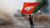 A BJP supporter waves a party flag as he celebrates after learning the initial election results in New Delhi, on May 23.