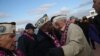 Pearl Harbor survivors embrace at a ceremony marking the 72nd anniversary of the attack on Hawaii on December 7. (Getty Immages/AFP/John Moore)