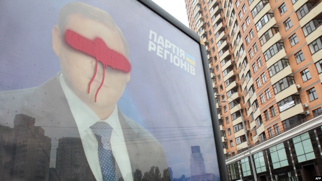 A billboard for Mykhaylo Dobkin is shown defaced in Kyiv in May. Dobkin's brother, Dmytro, is one of those named as a suspected vote buyer.