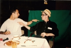 Zoran Stevanovic (left) and French journalist Paul Marchand sit in the Holiday Inn.