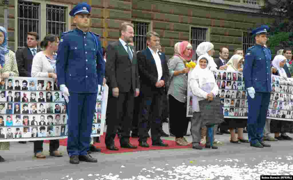 Bosnian police stand at attention as the trucks drive through Sarajevo.