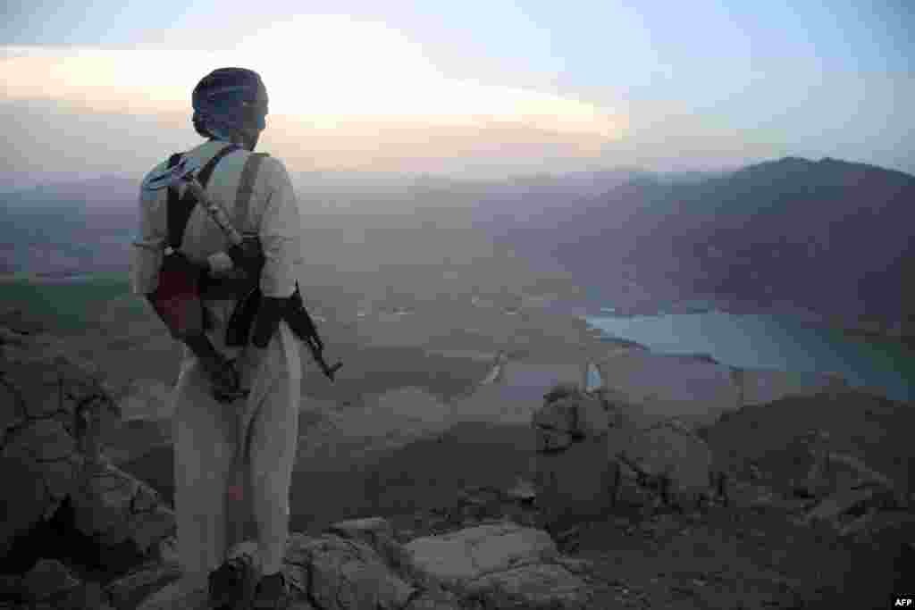 An armed Yemeni tribesmen stands overlooking the great Dam of Marib, (aka the Dam of Arim) in Marib province on September 28. (AFP/Abdullah Hassan)