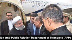 Telangana state Governor E.S.L. Narasimhan shakes hands with Iranian President Hassan Rohani (2L) upon his arrival at Begumpet airport in Hyderabad, India on February 15.