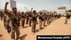 Huthi fighters in Yemen chant slogans as they take part in a gathering in the capital, Sanaa, in July.