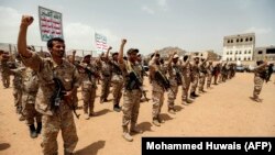 Huthi fighters in Yemen chant slogans as they take part in a gathering in the capital, Sanaa, in July.