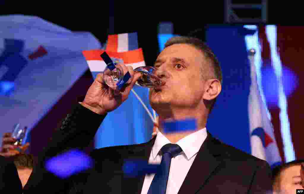 The leader of the conservative opposition Croatian Democratic Union party, Tomislav Karamarko, celebrates initial results of general elections in Zagreb. Croatia's conservative opposition was leading the vote count after a general election dominated by concerns over the migrant crisis and a sluggish economy. (AFP)