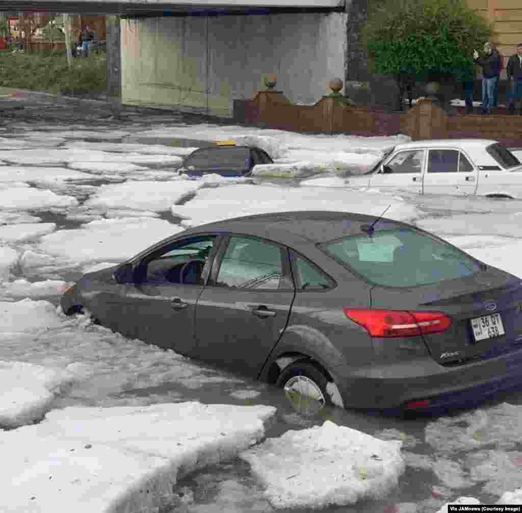 Cars drift among clumps of ice on the streets of Gyumri, Armenia.&nbsp;This is the aftermath of a combined rain and hailstorm that struck Armenia&rsquo;s second city on July 13. &nbsp;