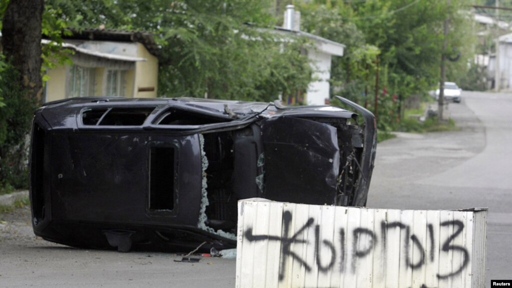 "Kyrgyz Zone" is spray-painted on a concrete block in the middle of a street in Osh on June 13.