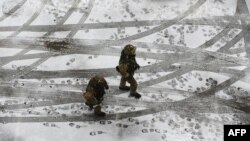 Ukrainian soldiers patrol a street in the eastern city of Kramatorsk.